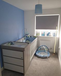 a baby's room with a crib and dresser