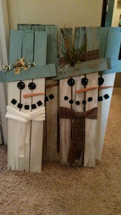 two snowmen made out of old wooden boards