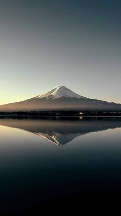 the mountain is reflected in the still water