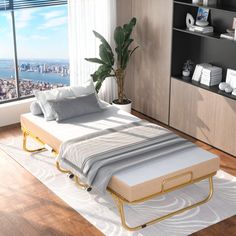 a bed sitting on top of a hard wood floor next to a window with a city view