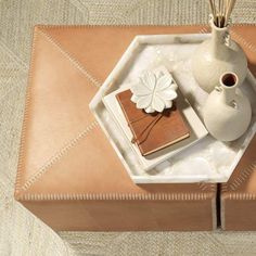 a tray with some books and a vase on it