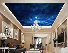 a living room filled with furniture and a painting on the ceiling