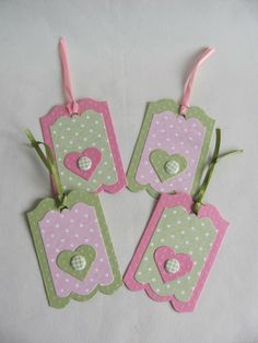 four pink and green tags with hearts on them