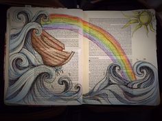 an open book with a drawing of a boat on the water and rainbow in the background