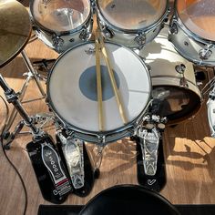 a drum set up with two sticks in the middle