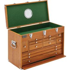 an open wooden chest with drawers and green lining