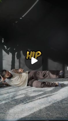 a man laying on the ground in front of a black background with text that reads hip