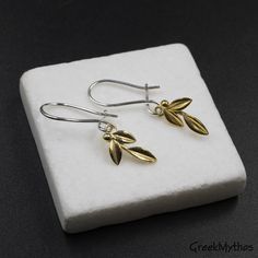 Gold Olive Leaves Small Dangle Earrings, Olive Twig Earrings, Olive Branch Delicate Earrings, Greek Goddess Athena Symbol, Greek Jewelry Elegant and delicate dangle earrings 24 karats gold plating on 925 sterling silver Hallmarked 925 onto the back Drop length: 30 mm Gold olive branch: 15 x 8 mm 925 Sterling silver latch back closure Please take into consideration that gold plating will wear off over time. If you take good care and how you wear your jewelry and depending on your skin type it can Athena Symbol, Twig Earrings, Greek Goddess Athena, Olive Jewelry, Small Dangle Earrings, Goddess Athena, Olive Leaves, Goddess Jewelry, Art Necklaces