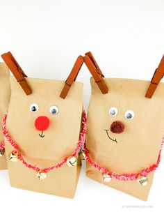 two brown paper bags with reindeer faces on them