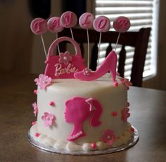 a white cake with pink decorations on top