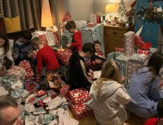 a group of people sitting around wrapped presents