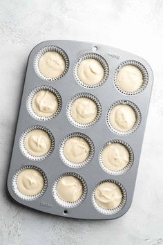 a muffin tin filled with cupcake batter