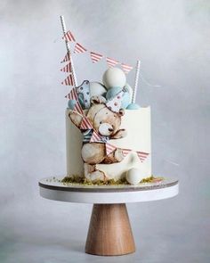 a cake with a teddy bear and flags on it