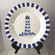 a blue and white plate with a lighthouse on it