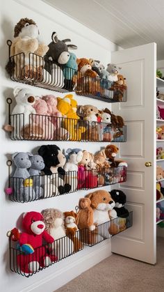 a wall filled with lots of stuffed animals