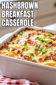 hashbrown breakfast casserole with bacon and green onions in a white dish