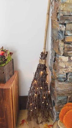 a broom sitting on top of a wooden table next to a pile of pumpkins