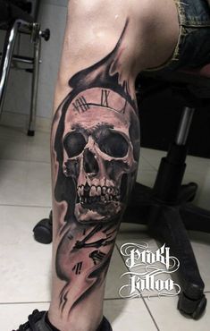 a man's leg with a clock and skull tattoo on the side of his leg