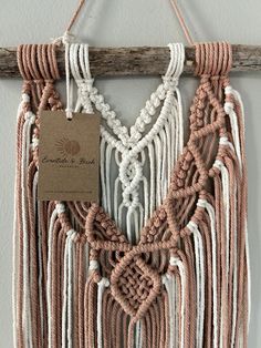 a wall hanging made out of rope and wood