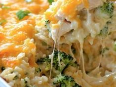 a casserole dish with broccoli and cheese being lifted from the casserole