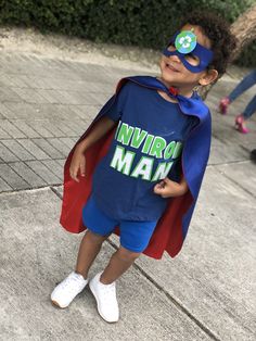 a little boy dressed up as a super hero