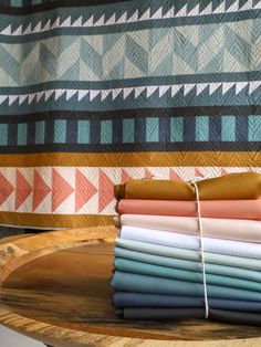 a stack of folded fabric sitting on top of a wooden tray