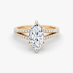 a yellow gold engagement ring with an oval cut diamond and pave set side stones