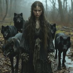 a woman with long hair standing in the middle of a forest surrounded by black wolfs