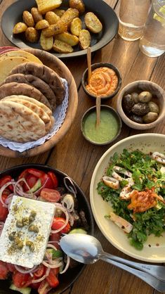 a table topped with plates and bowls filled with different types of food on top of it