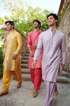 three men are walking down the steps together in bright colored clothing and shoes, one is wearing