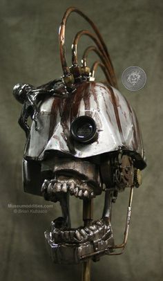 a silver and black robot head with wires attached to it