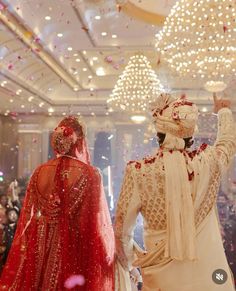 the bride and groom are throwing confetti in the air