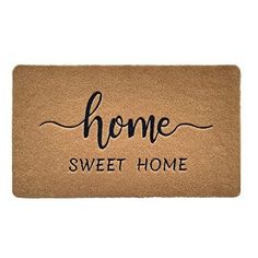 a door mat with the words home sweet home on it, in black ink and handwritten