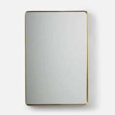 a square mirror with a gold frame