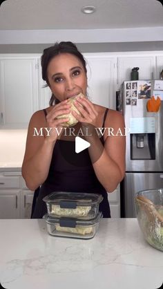 a woman eating food in her kitchen while looking at the camera with text overlay