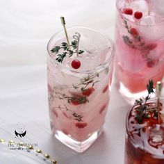 three glasses filled with drinks sitting on top of a table