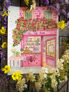 a drawing of a pink store with flowers surrounding it