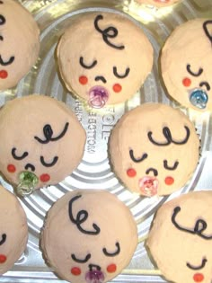 there are many cupcakes with faces on them