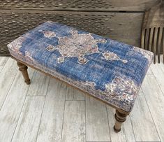 a blue bench sitting on top of a wooden floor