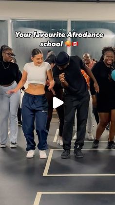 a group of people standing around each other in front of a wall with the words your favorite afro dance school on it