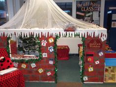 a christmas display in the middle of a building with decorations on it and a white canopy