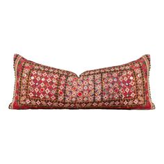 a red and gold decorative pillow on a white background