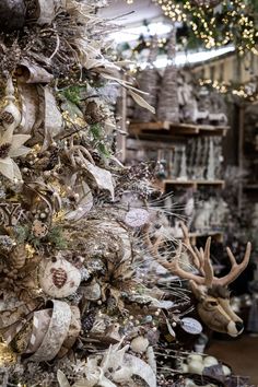 a christmas tree decorated with deer heads and ribbons