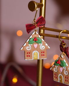 Handmade clay gingerbread house dangle earrings with burgundy velvet bows. Houses about 2.5 cm. About 3.5 cm long. Ah! The first Christmas pair of earrings for this year is a fact and it couldn't be other than Gingerbread house, it is known that I have a huge weakness for them! Made entirely of clay, with a cookie texture, hand painted, with tiny mistletoe and a gorgeous burgundy velvet bow to finish them off just right! And of course with golden steel hoops. Each piece of handmade jewelry is made entirely by hand, so there may be differences from the product in the photo! This makes each of our pieces of jewelry unique! All our handmade products come in a gift box! Care To keep your favorite jewelry as it was on the first day, store it with care, ideally alone, avoid contact with water an Gingerbread House Clay, Polymer Clay Gingerbread House, Clay Gingerbread House, Polymer Clay Gingerbread, Cookie Texture, Clay Gingerbread, House Earrings, Xmas Earrings, Velvet Bows