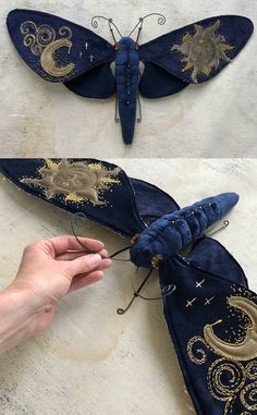 the butterfly is made out of blue velvet and has gold details on it's wings