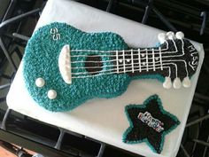 a birthday cake made to look like a guitar and star is on top of a stove