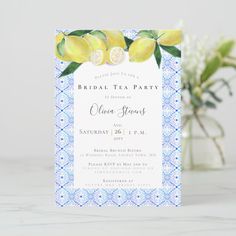 a blue and white bridal tea party with lemons on the table next to flowers