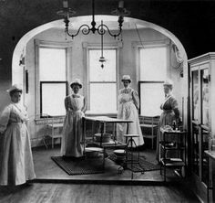 an old photo of some women standing in a room