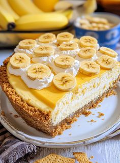 a piece of cheesecake on a plate with bananas and graham crackers around it