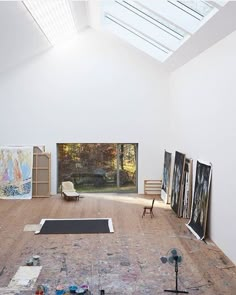 an artist's studio with multiple paintings on the floor